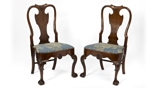 two antique wooden chairs with blue cushions