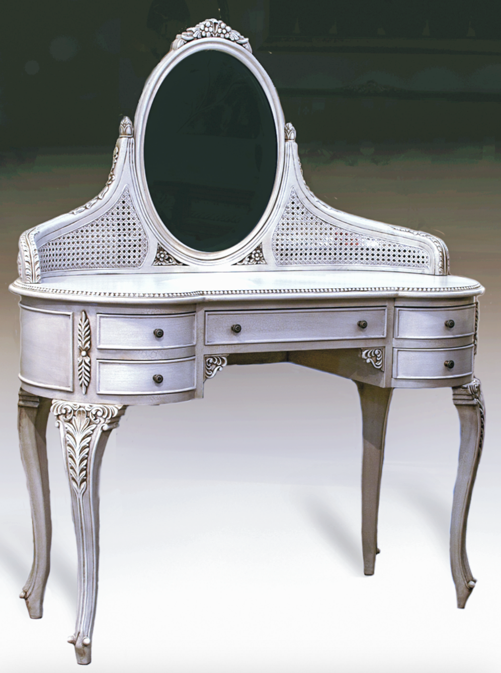 Elegant wooden dressing table with intricate carvings and upholstered seat.