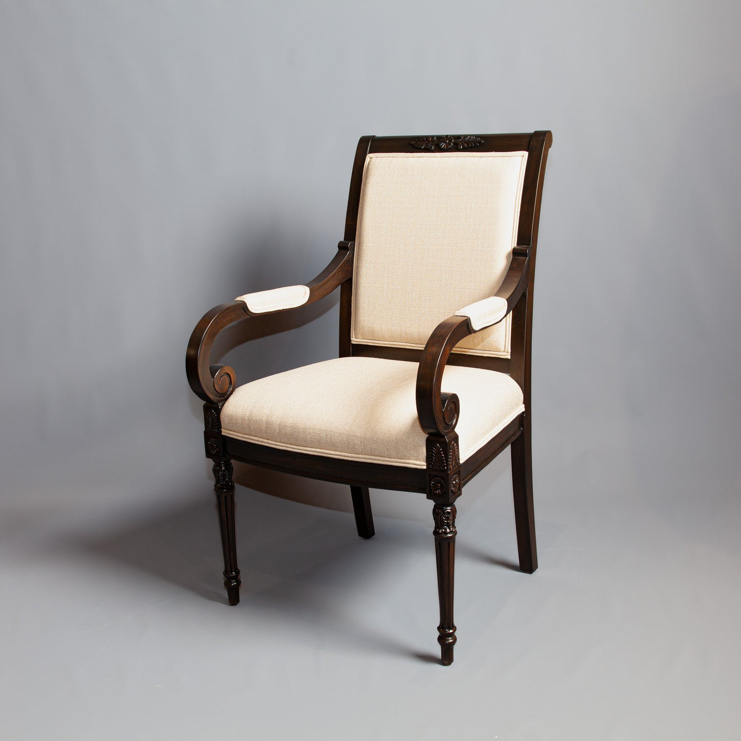 Detailed view of Empire-style armchair emphasizing its ornate design and comfort.