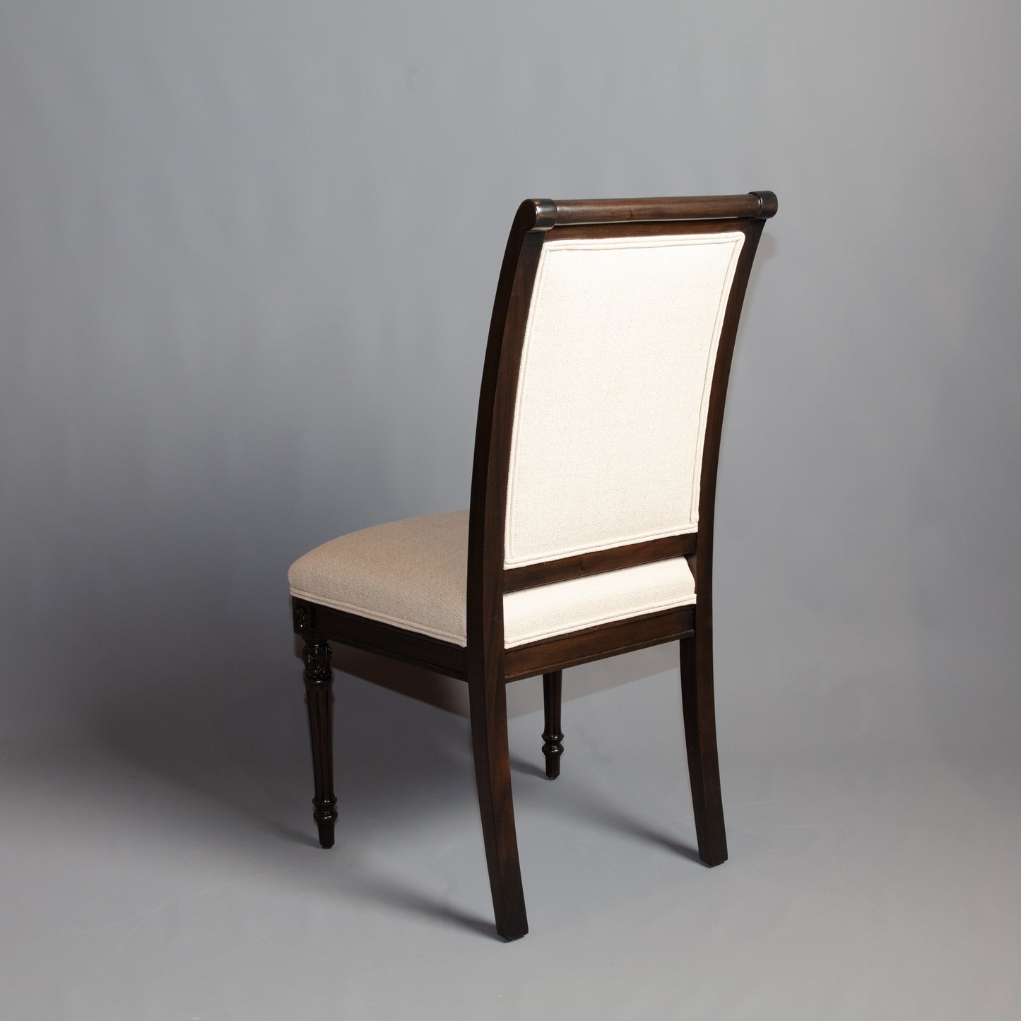 Side profile of Empire-style armchair displaying its elegant lines and craftsmanship.