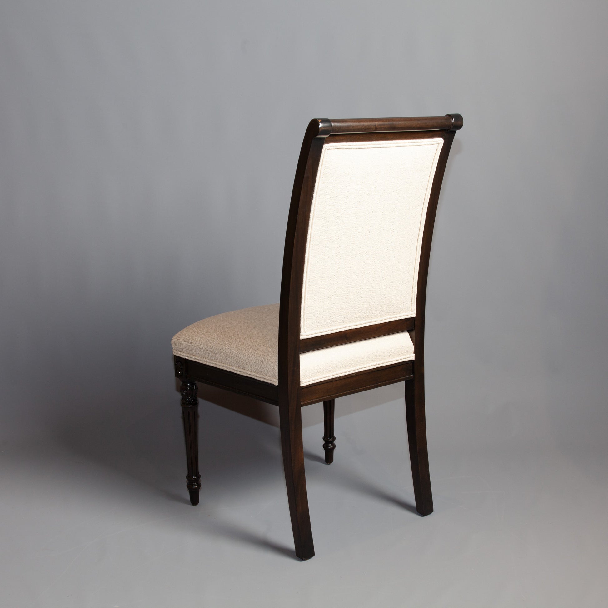 Side profile of Empire-style armchair displaying its elegant lines and craftsmanship.