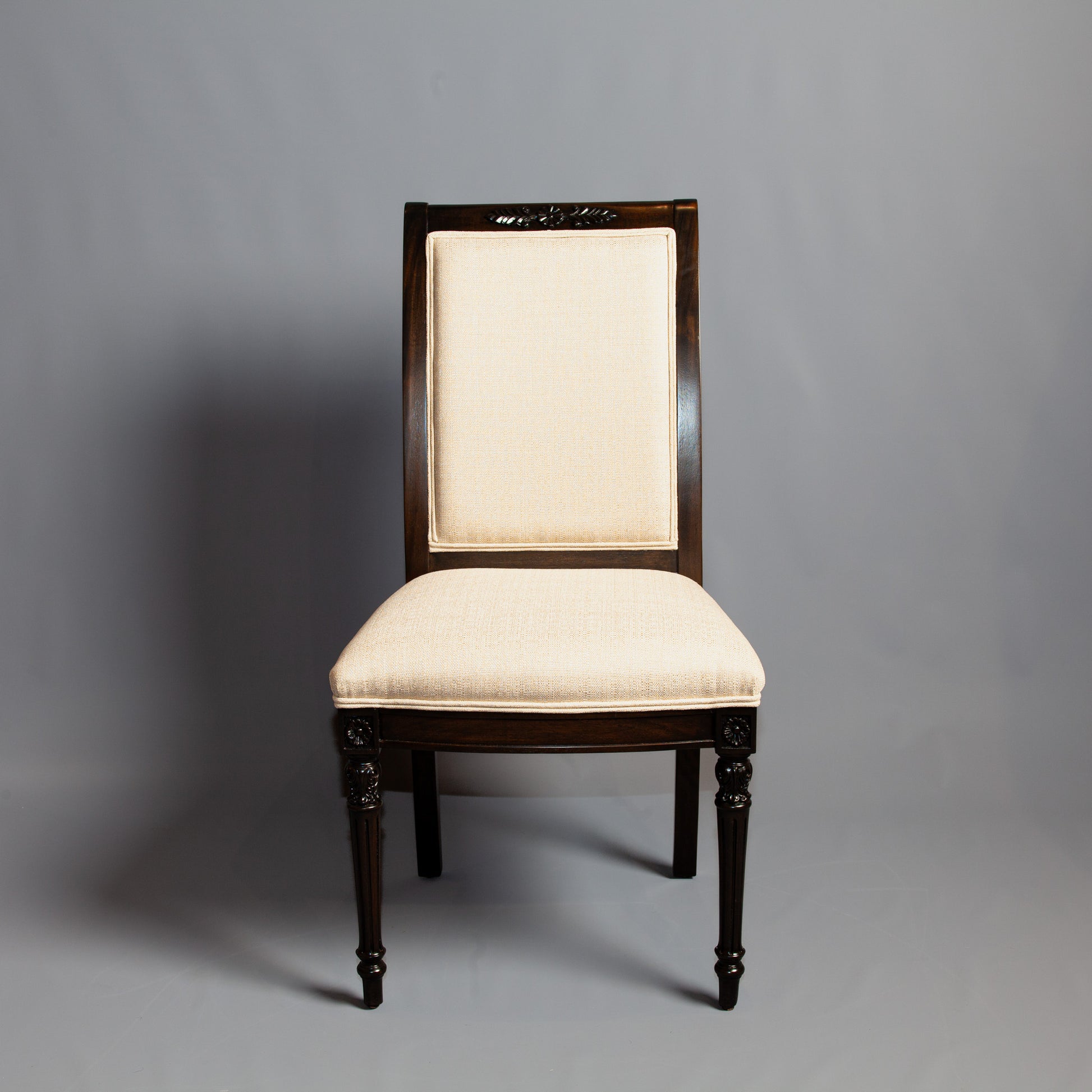 Empire-style side chair with striped upholstery and carved wooden frame.