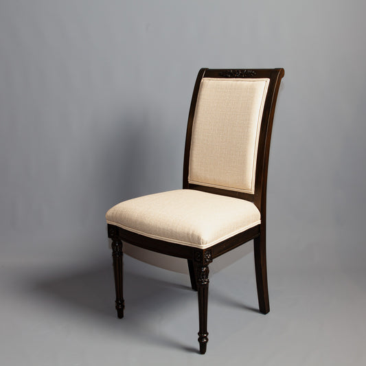 Front view of Empire-style side chair showcasing detailed carvings and striped fabric.