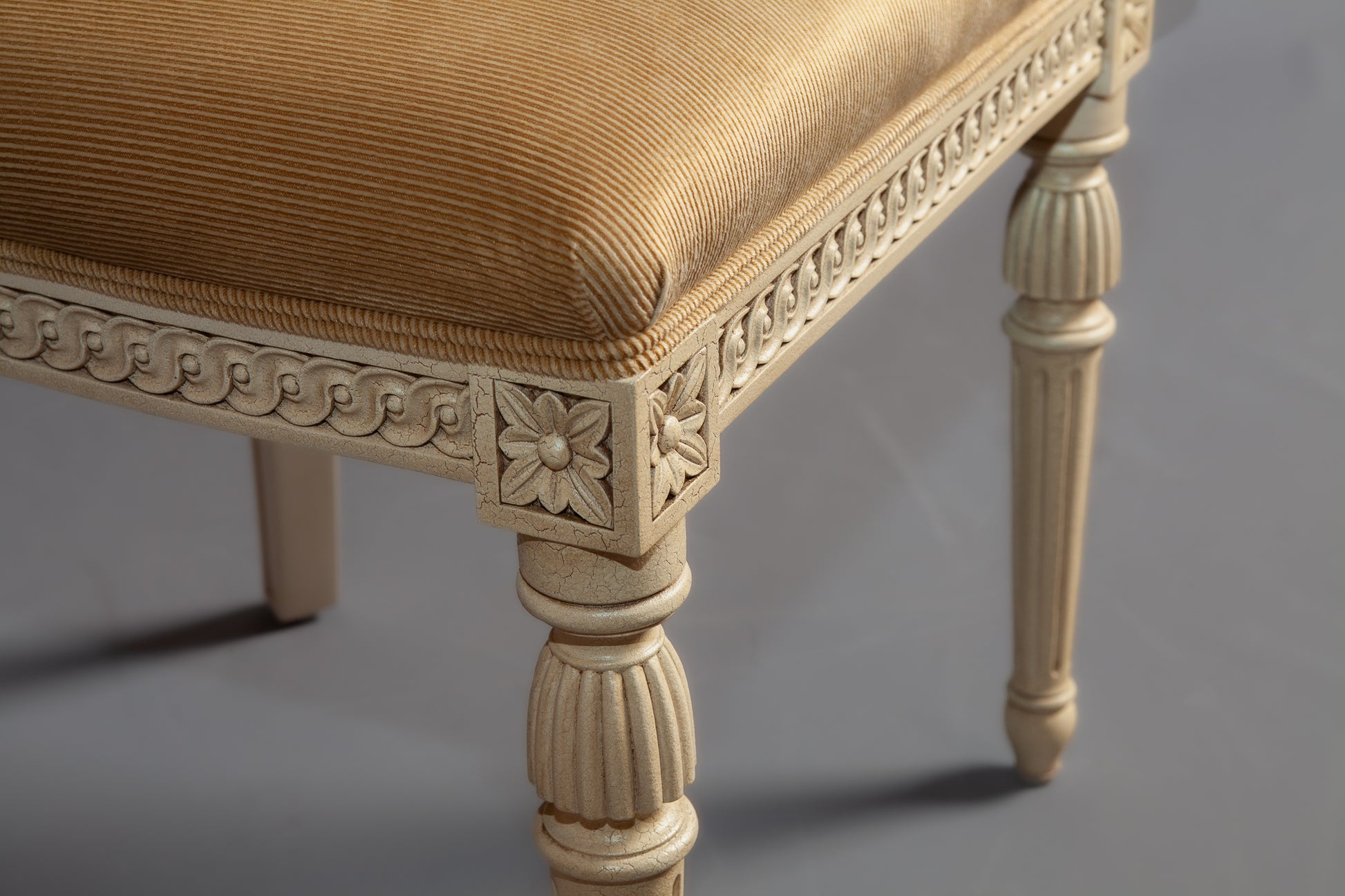 Detailed view highlighting the chair's leg and side carving.