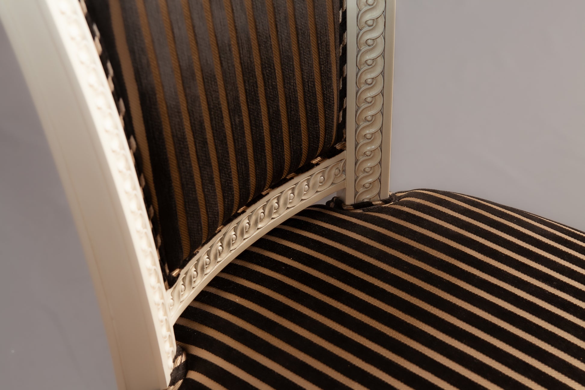Side profile highlighting the chair's sleek design and tapered legs.