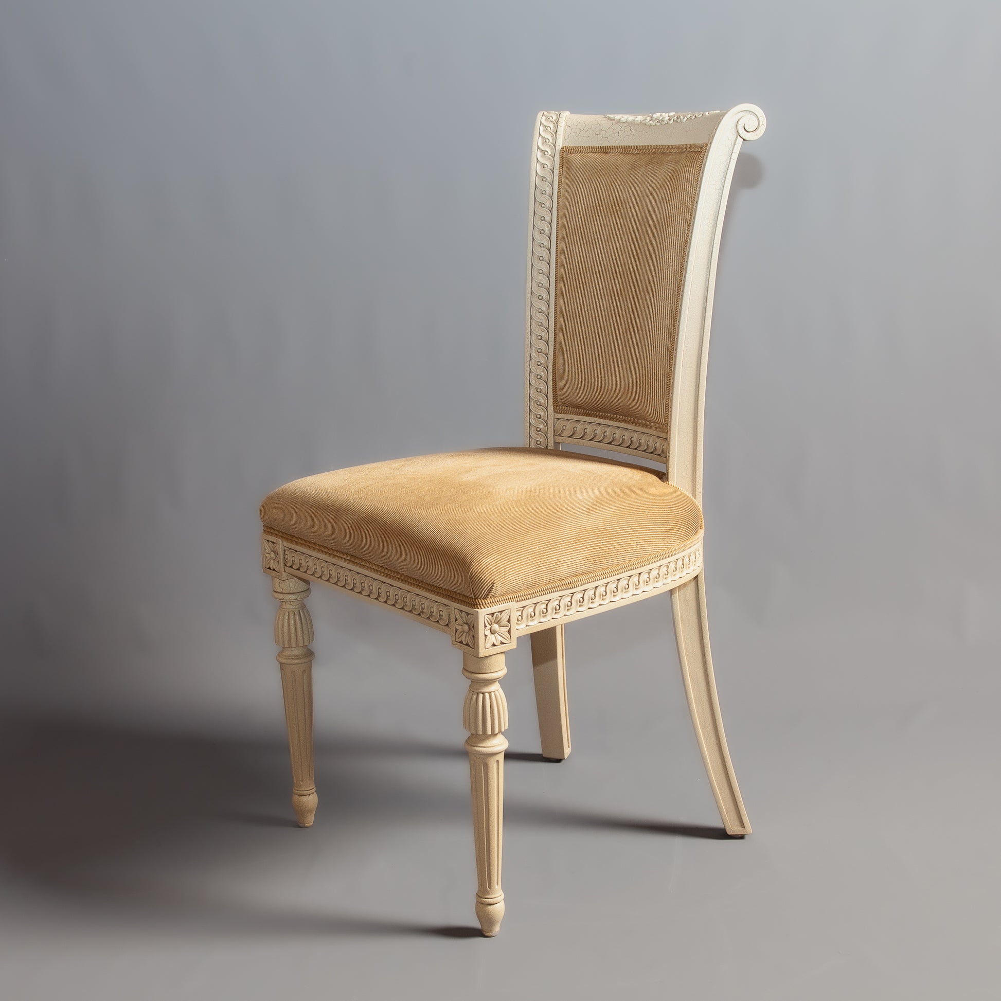 Detailed shot of the chair's backrest carvings and fabric texture.