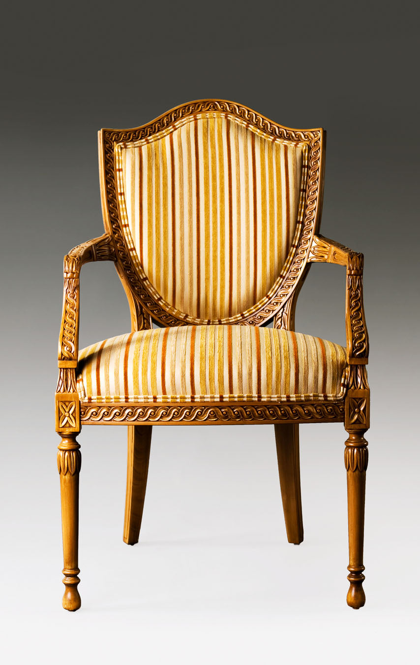 Hepplewhite armchair featuring a shield-shaped back and upholstered seat.
