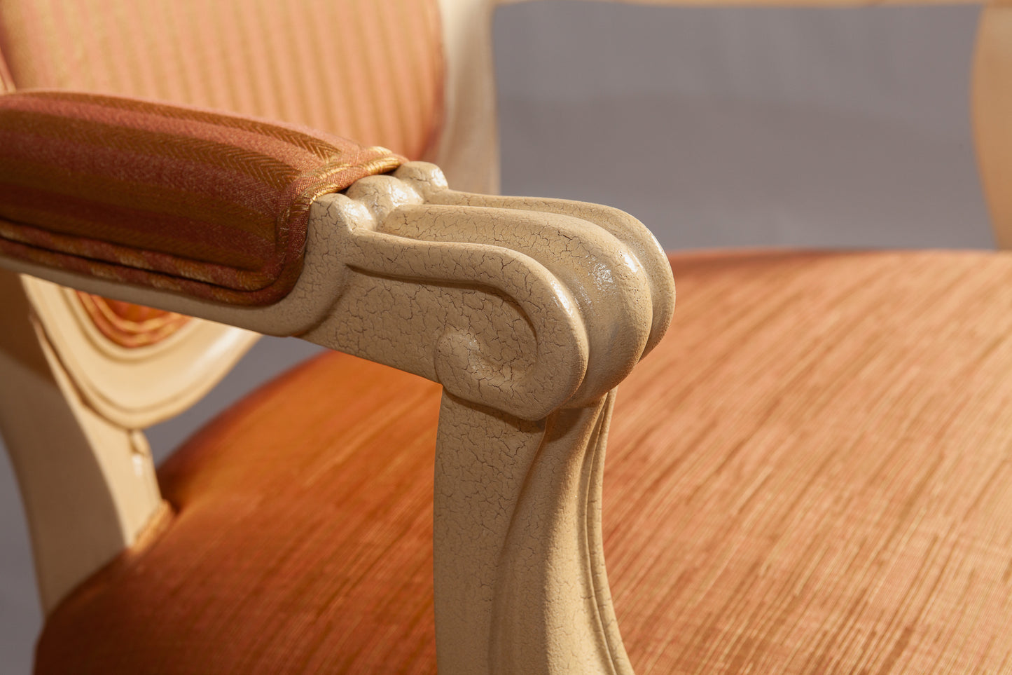 Close-up of the chair’s backrest showing elegant scrollwork and craftsmanship.