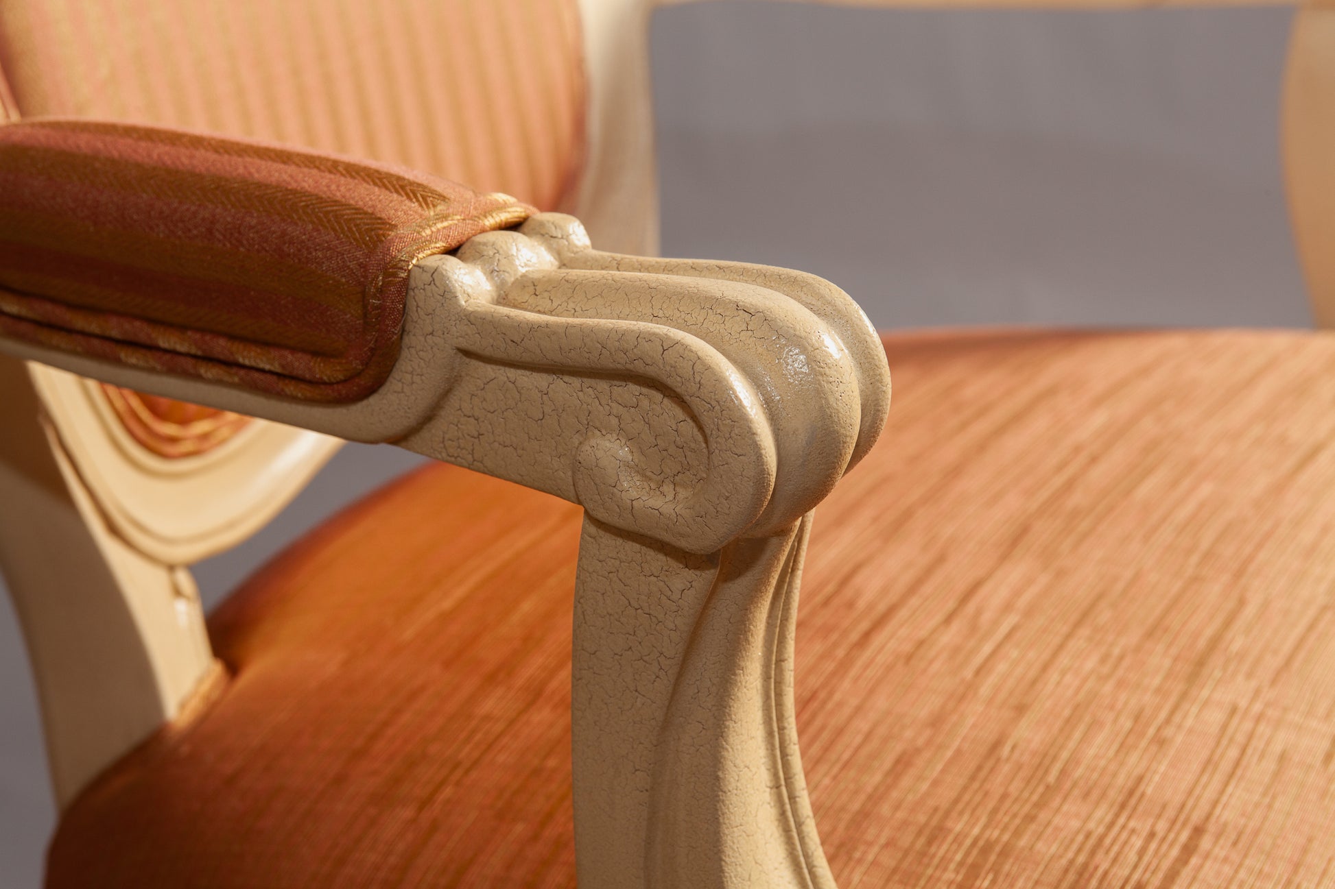 Close-up of the chair’s backrest showing elegant scrollwork and craftsmanship.