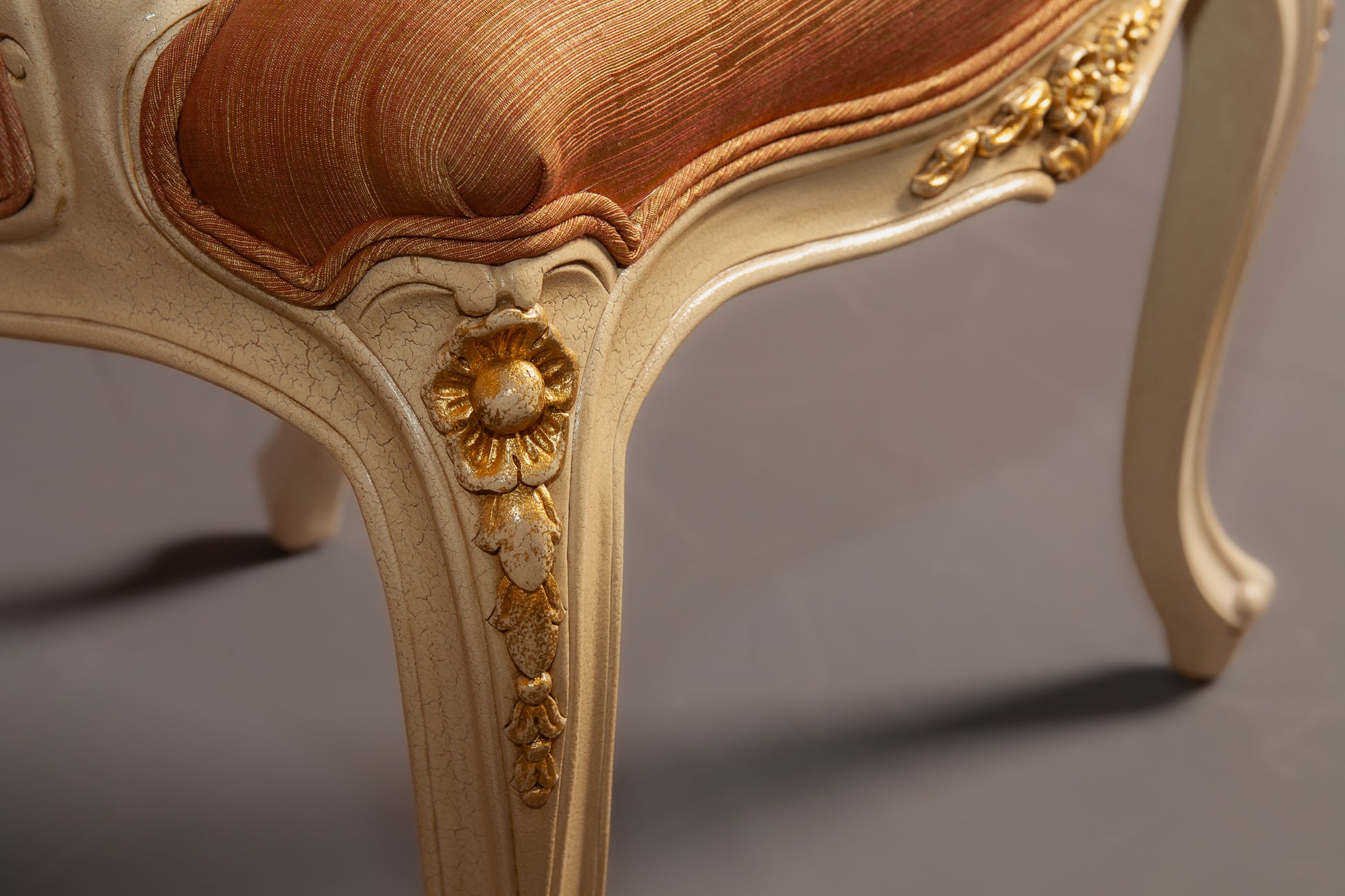 Angled perspective of Louis XV armchair emphasizing its refined curves and luxurious fabric.