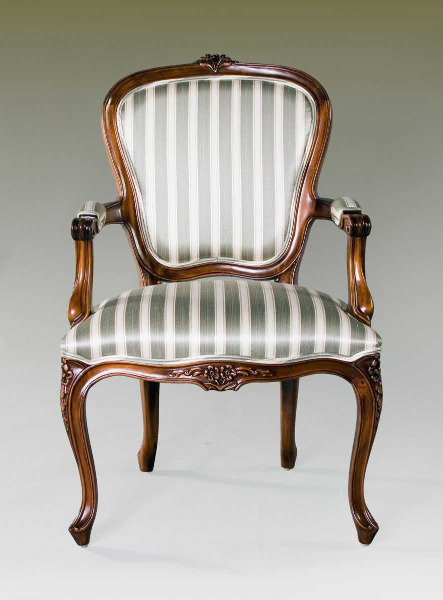 Ornate Louis XV armchair with upholstered seat and intricate wooden frame