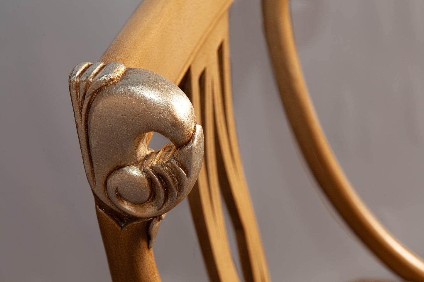 Side view of armchair showcasing detailed woodwork and plush upholstery.