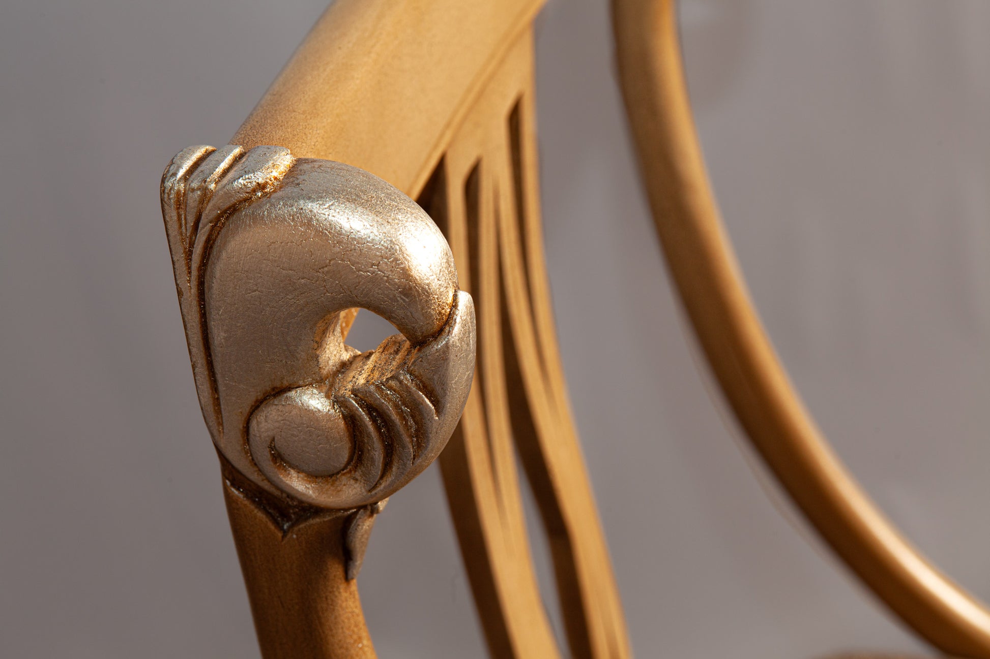 Side view of armchair showcasing detailed woodwork and plush upholstery.