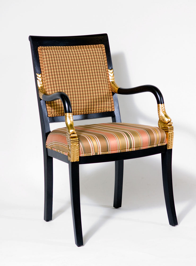 Dolphin armchair featuring unique dolphin carvings and cushioned seat.