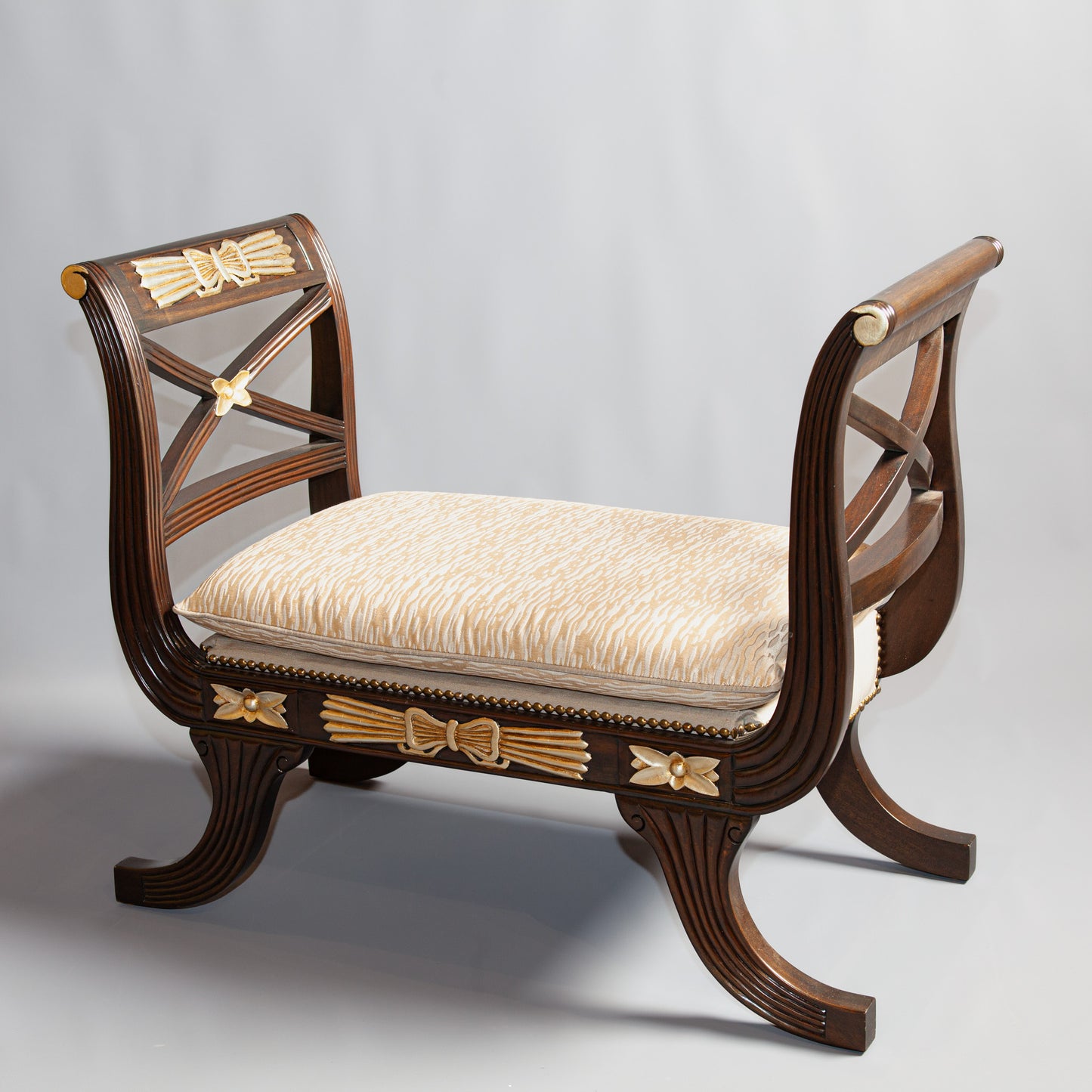 Side view of Empire armchair highlighting detailed carvings.