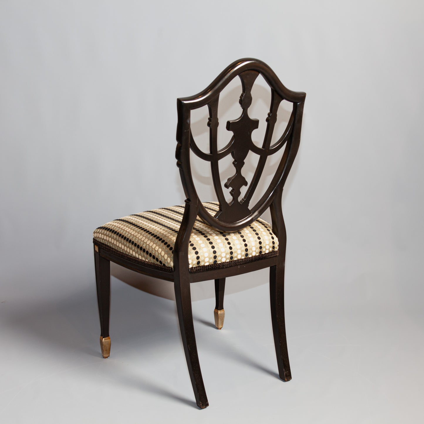 Prince of Wales side chair with carved backrest and upholstered seat.