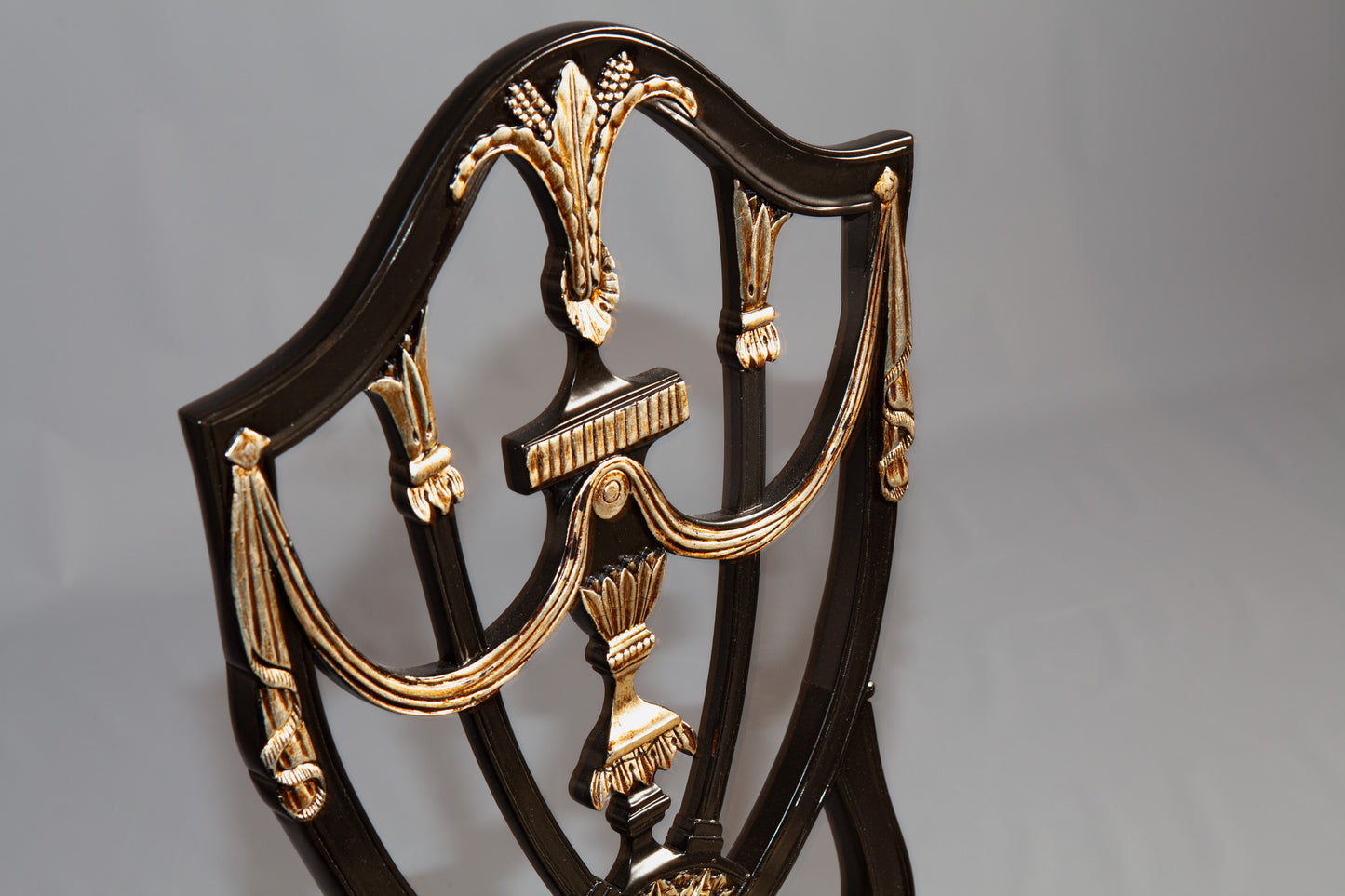 Detail view of Prince of Wales chair highlighting detailed carvings and cushioned seat.