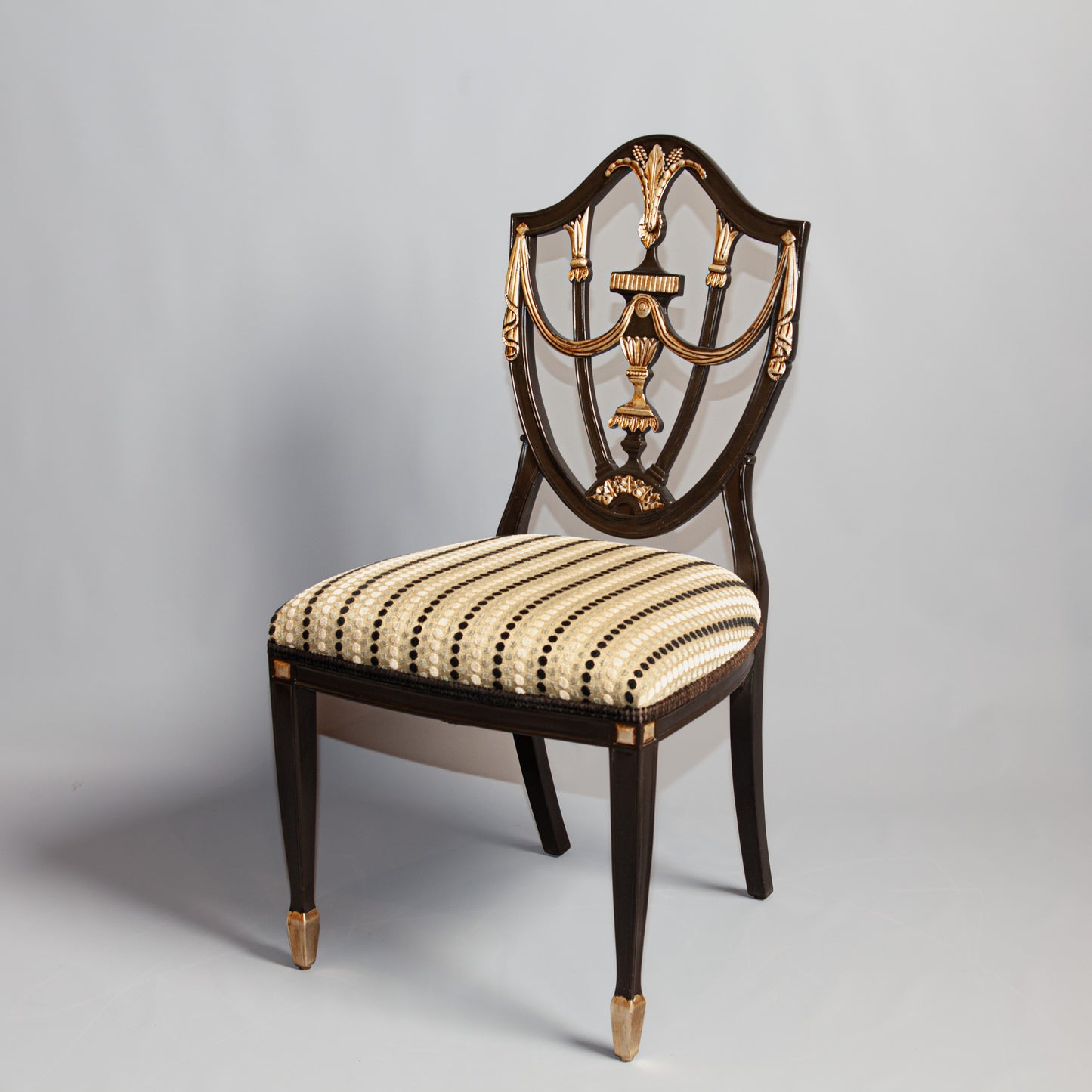 Prince of Wales side chair with carved backrest and upholstered seat.