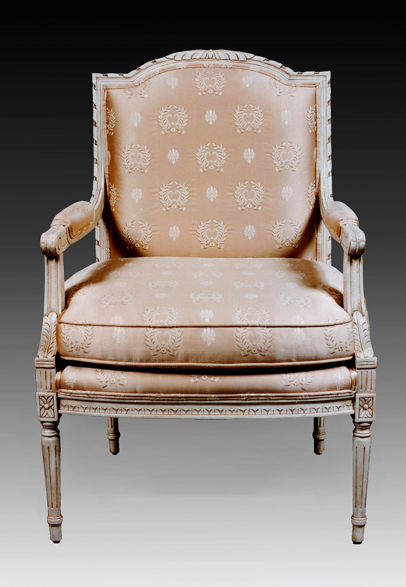 Louis XVI-style accent chair with intricate hand-carved details and upholstered seat.