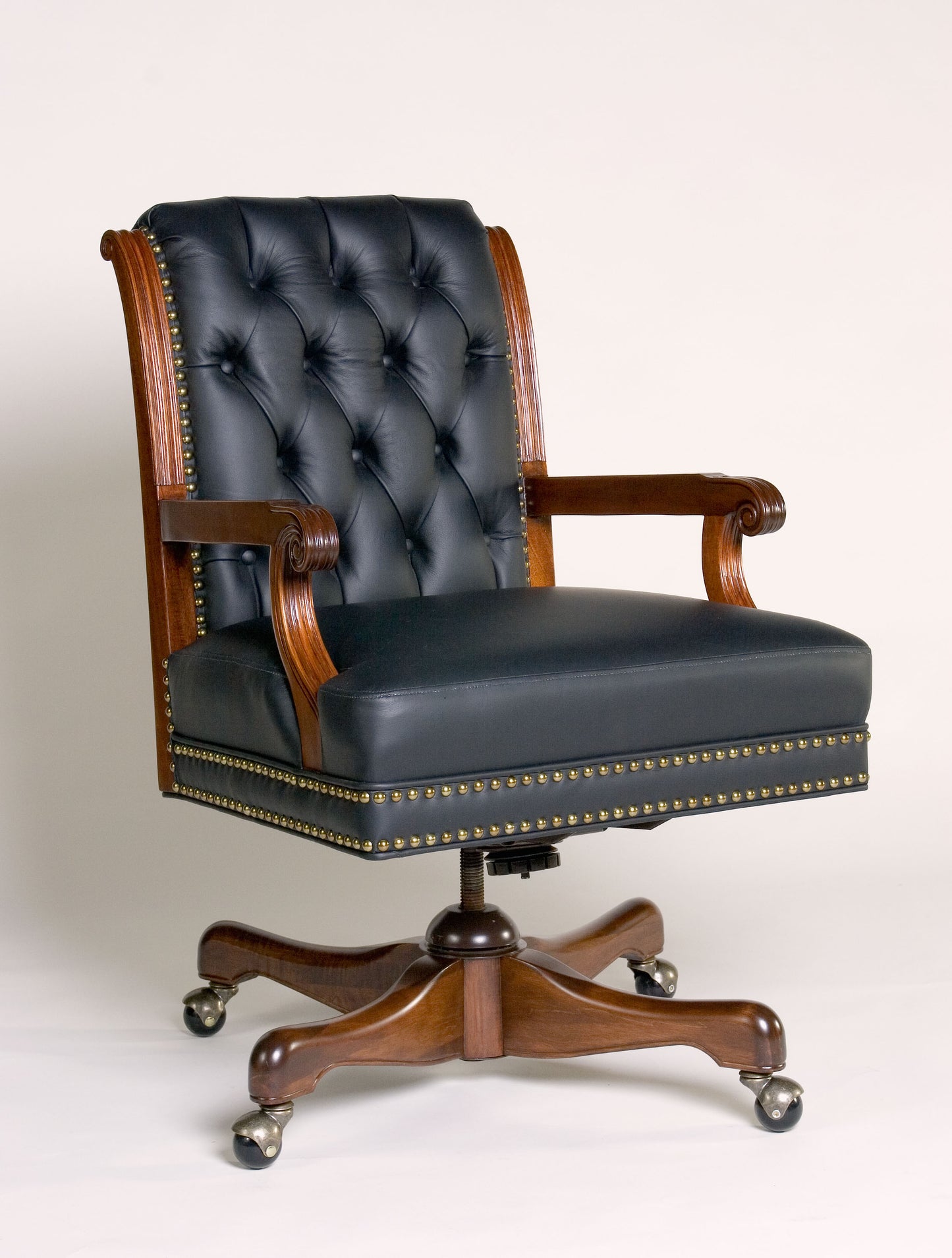 Swivel armchair with a luxurious leather seat and a sturdy wooden base.