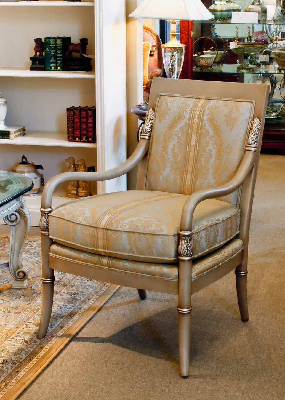 Empire-style chair with elegant upholstery and fluted wooden legs.