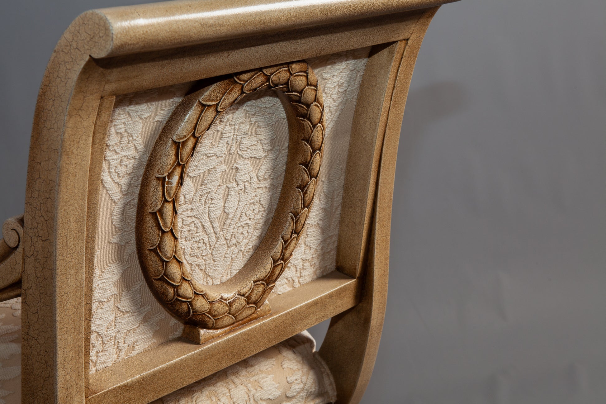 Classic wooden armchair with elegant carvings and plush upholstery.