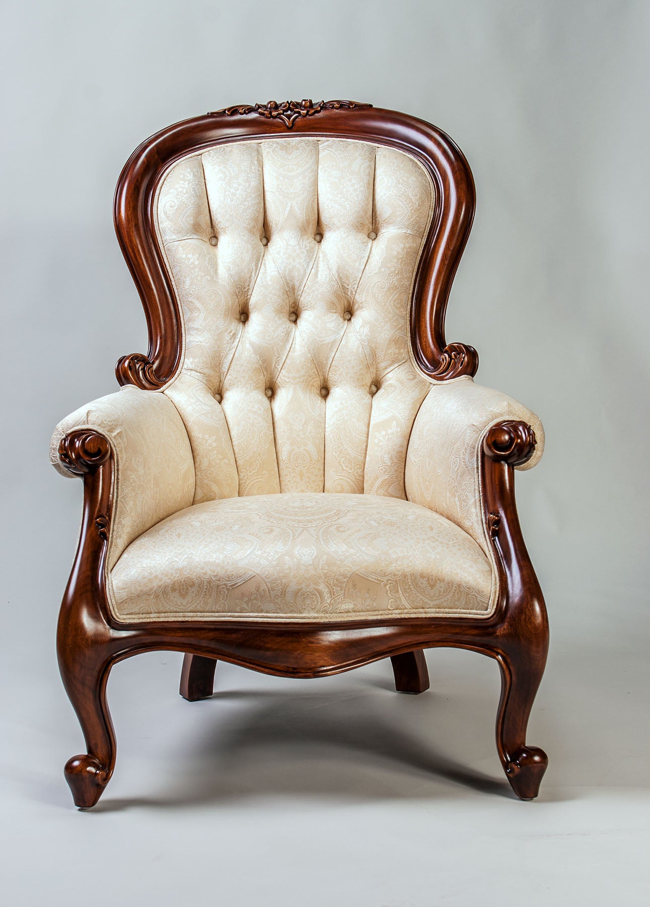 Grandfather armchair featuring elegant woodwork and comfortable seating.