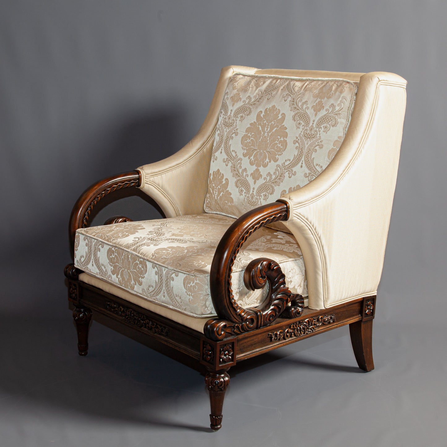 Side angle of a refined wooden armchair emphasizing its craftsmanship.