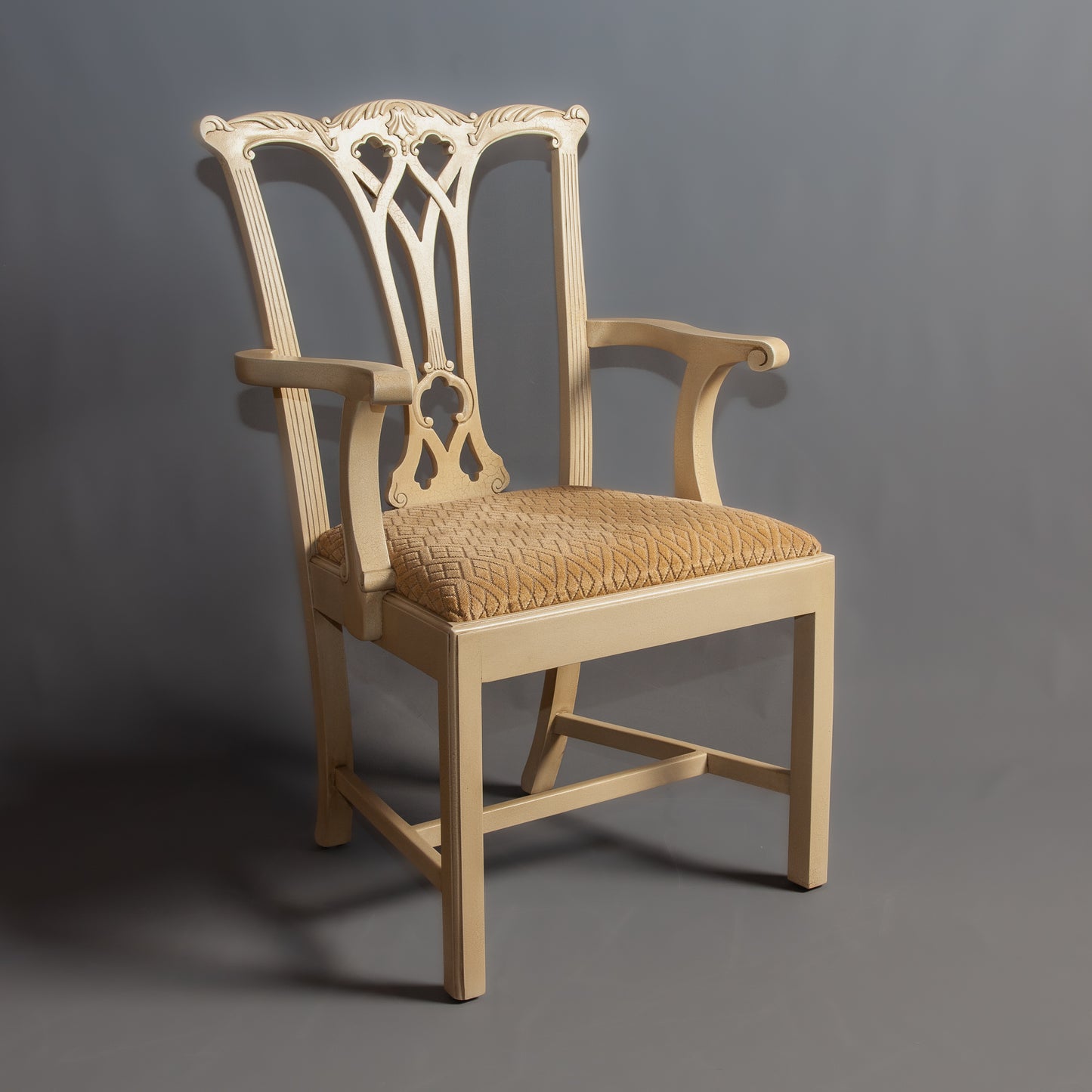 Side view of a wooden chair showcasing intricate carvings and cushioned seating.