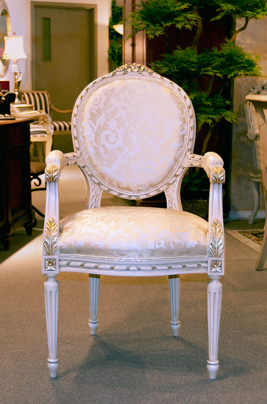 Louis XVI armchair with fluted legs and elegant upholstery