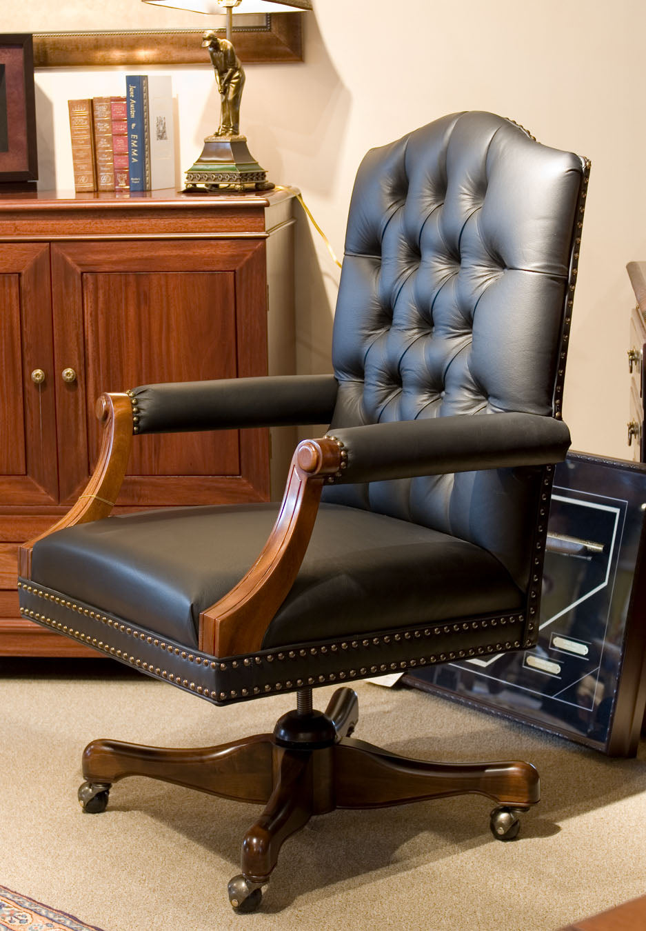 Classic swivel leather chair with tufted back and wooden frame