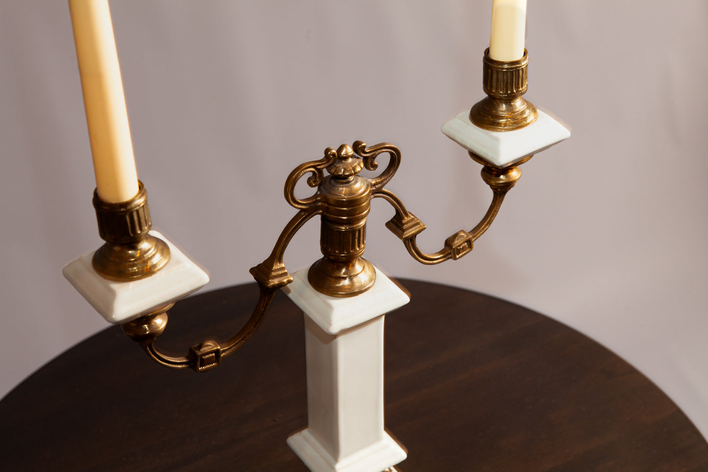 Side view of a stylish porcelain and brass candle holder showcasing its detailed craftsmanship.