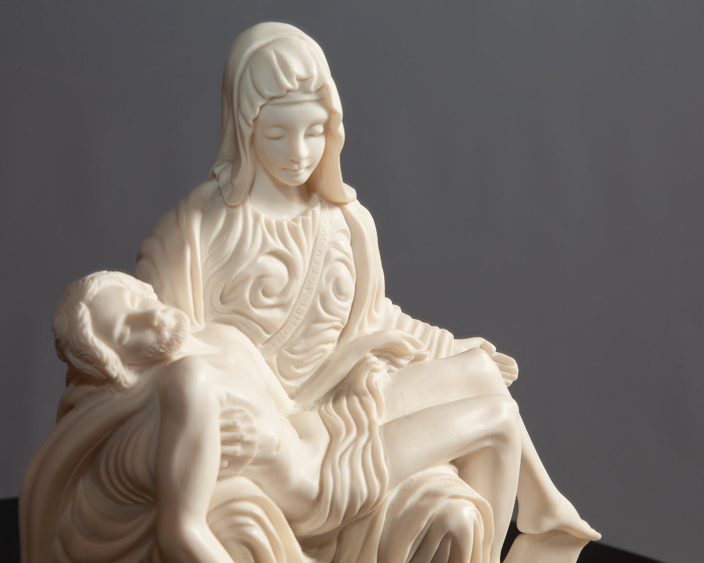A white Pietà sculpture depicting Mary holding Jesus