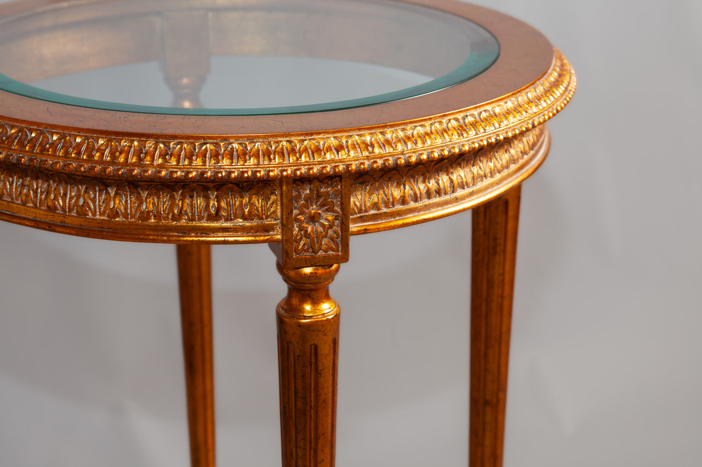 Elegant wooden chair with intricate carvings and upholstered seat.