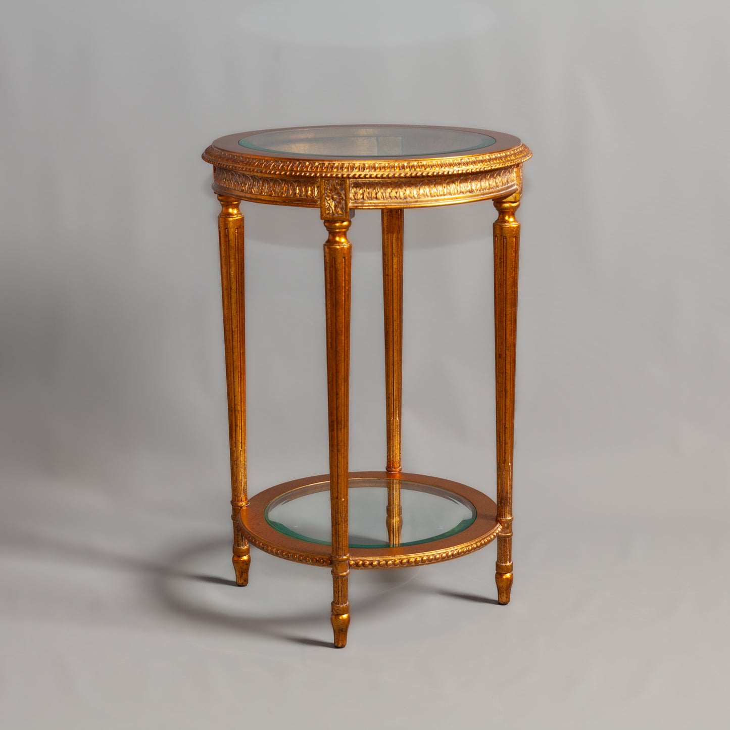 Front view of a classic wooden chair with ornate carvings and fabric upholstery.