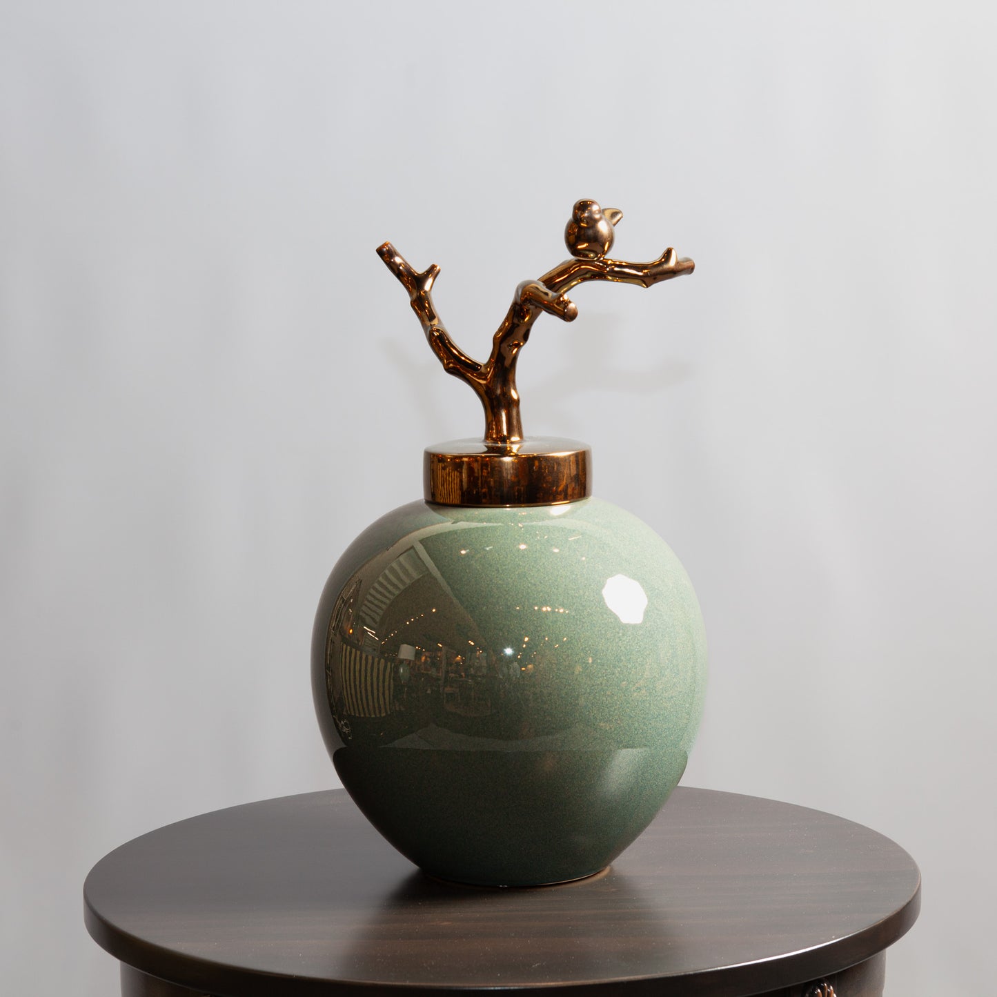 Porcelain jar with twig-shaped lid, combining elegance with natural elements.