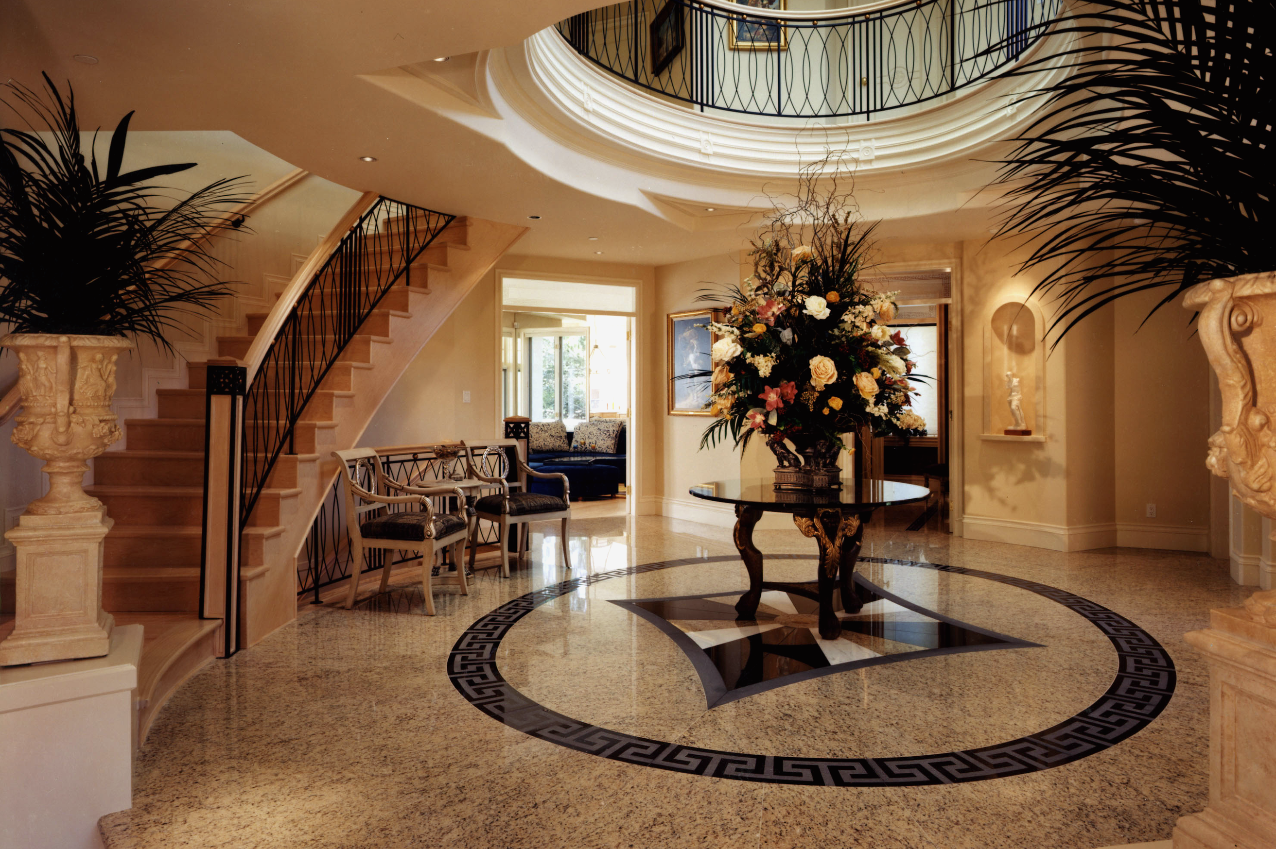 Luxury foyer with curved staircase - House of Chippendale