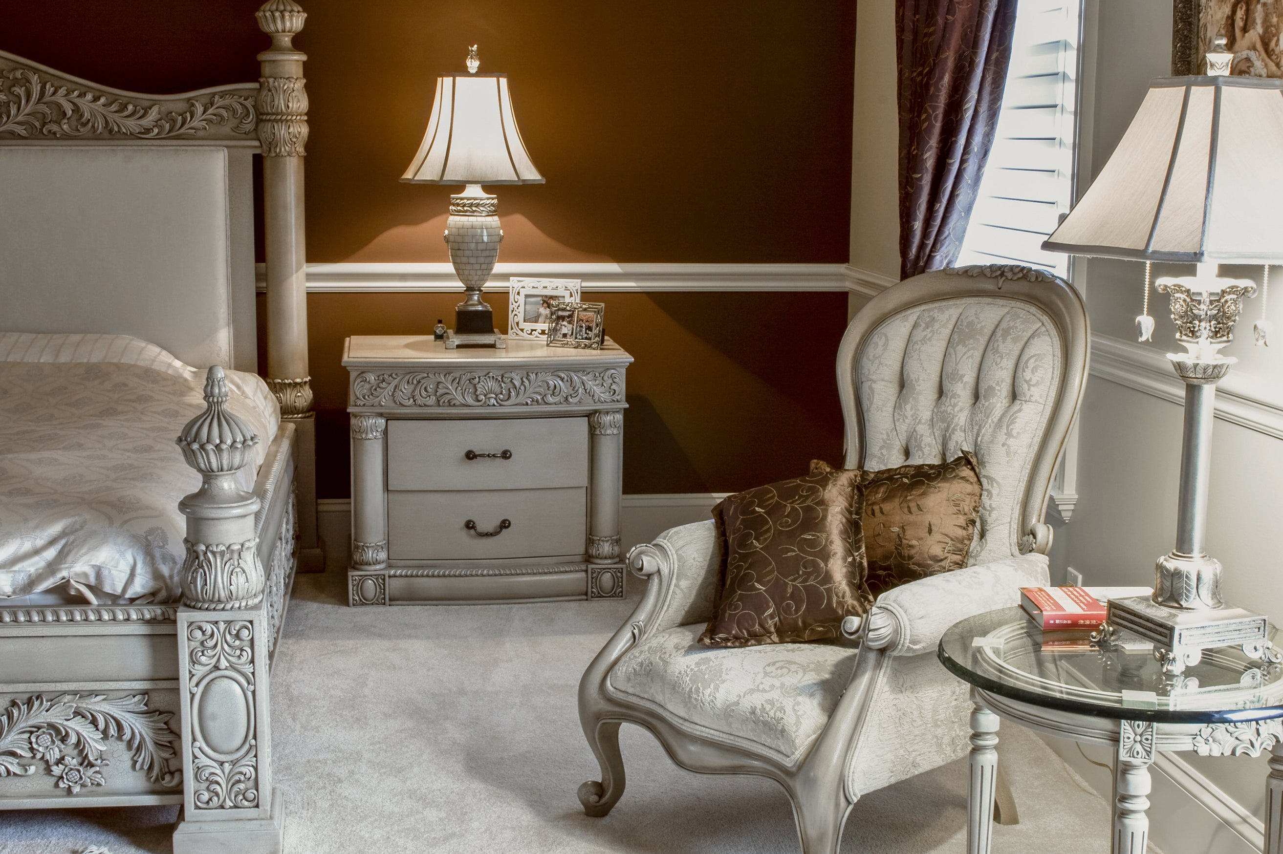 Ornate carved bed and chair in a bedroom - House of Chippendale