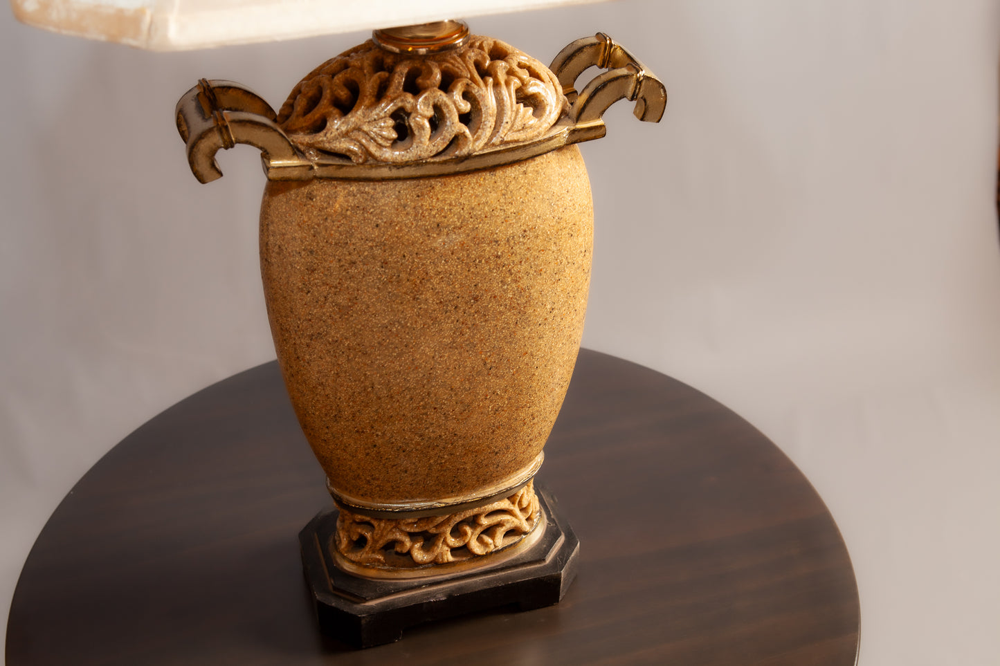 A gold and beige decorative table lamp base