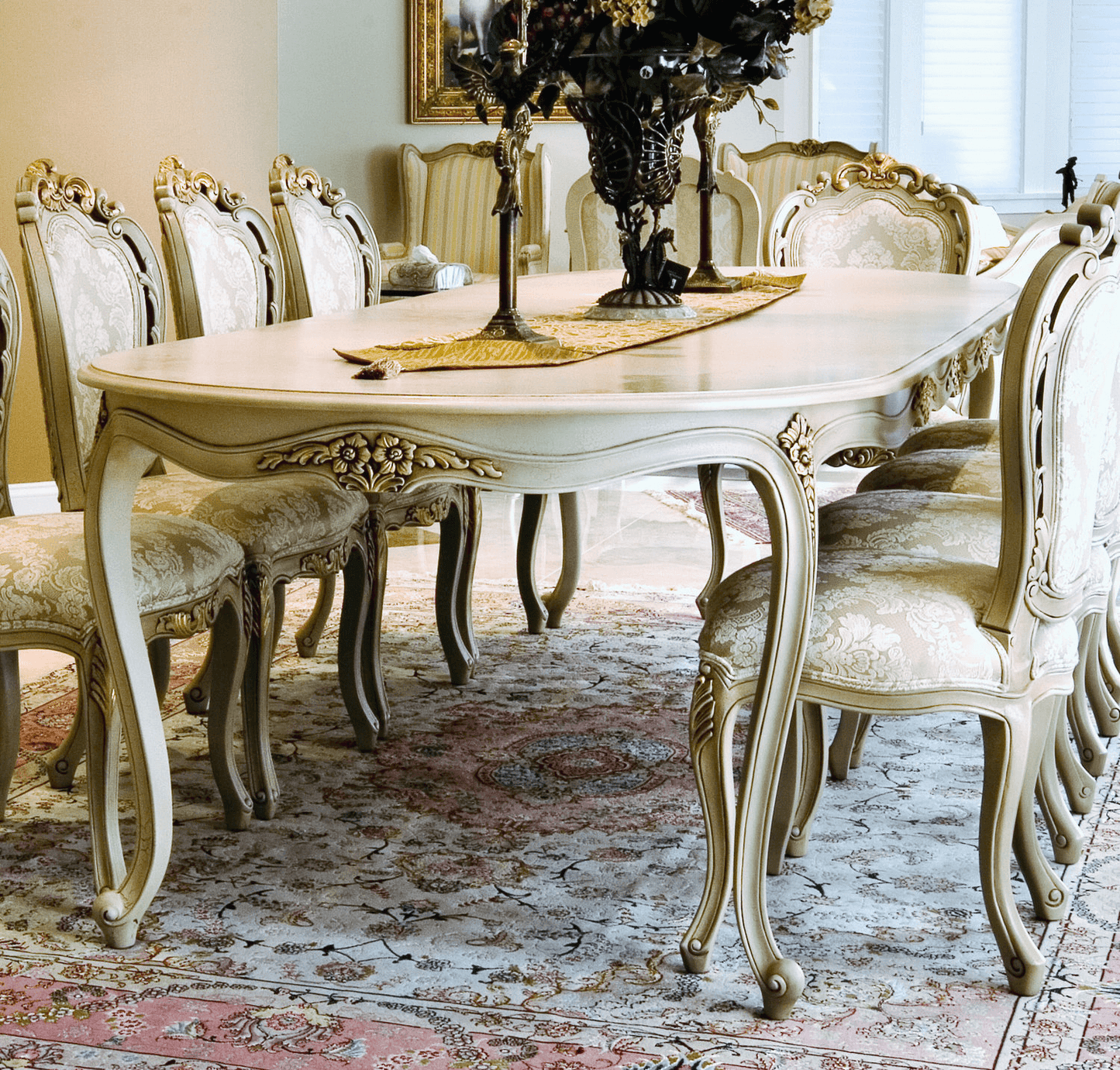 Elegant Louis XV-style dining table with ornate carvings and curved legs