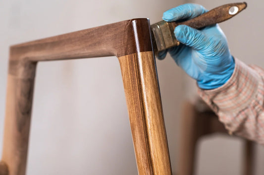 carpenter applying lacquer