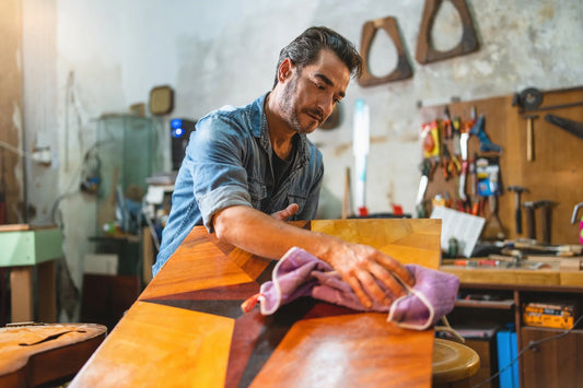 carpenter craftsman cleans an inlaid board