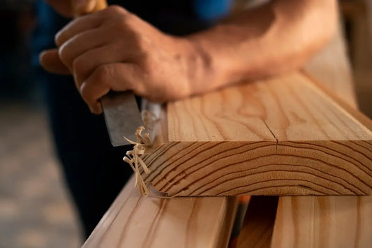 chiseling a wooden board edge