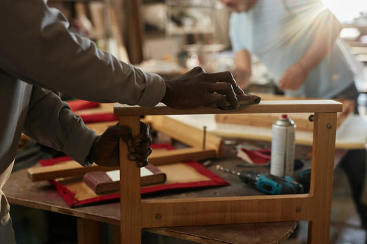 close up of man sanding wooden furniture