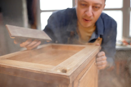 man crafting wooden cabinet