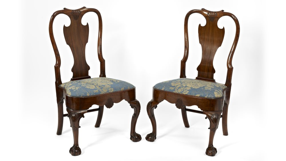two antique wooden chairs with blue cushions