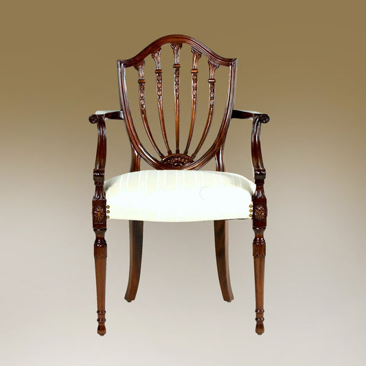 Prince of Wales armchair with carved backrest and upholstered seat.