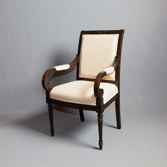Detailed view of Empire-style armchair emphasizing its ornate design and comfort.