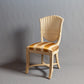 Classic wooden chair with intricate backrest carvings and cushioned seat.