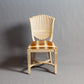 Front view of a classic wooden chair with detailed carvings and upholstered seat